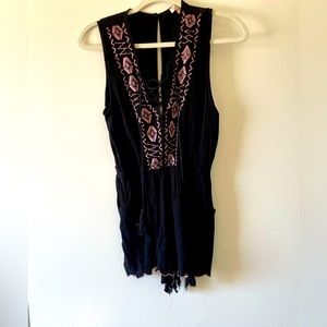 Worn once. black romper with floral appliqué
